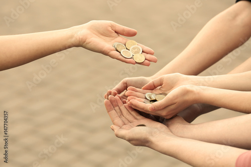 Woman sharing money with poor people