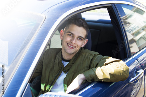 young driver smiling in the car