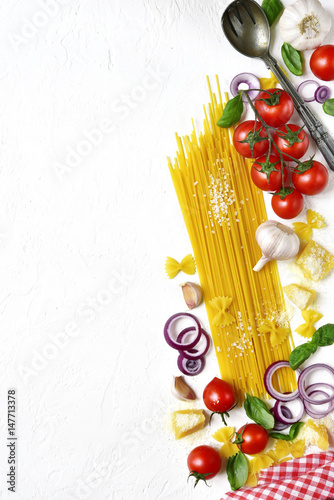Traditional ingredients of italian cuisine : pasta,cheese and assortment of vegetables.Top view with copy space.