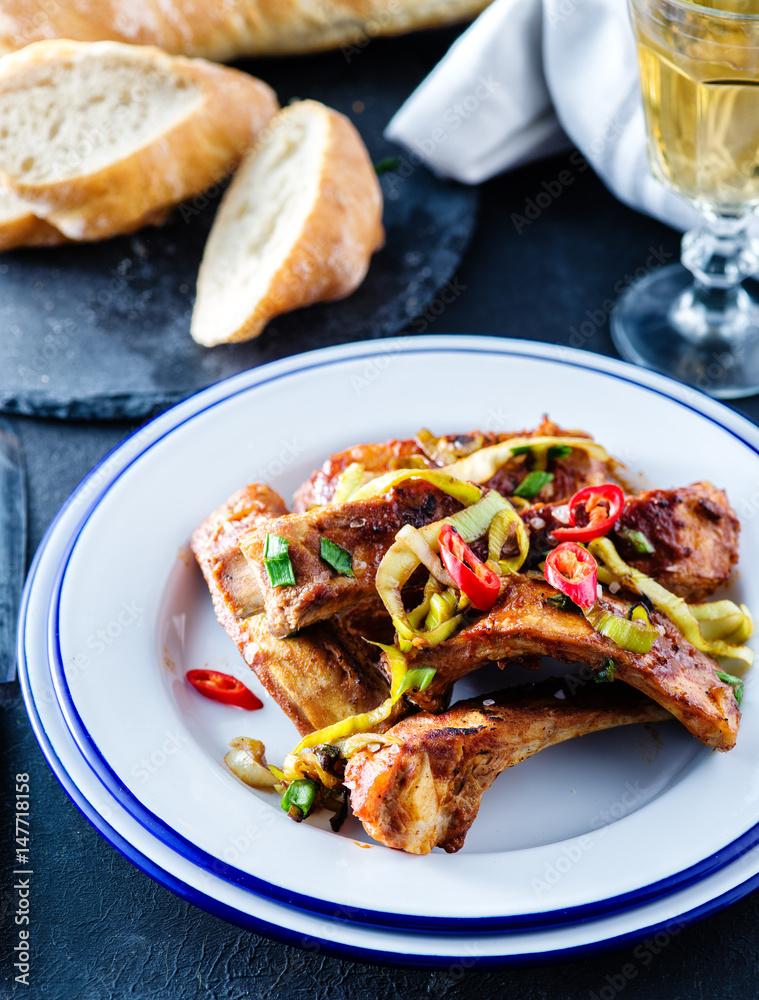 Roasted sliced barbecue pork ribs, seasoned with a spicy basting sauce and served with vegetables. Roasted sliced barbecue pork ribs, seasoned with a spicy basting sauce and served with vegetables.