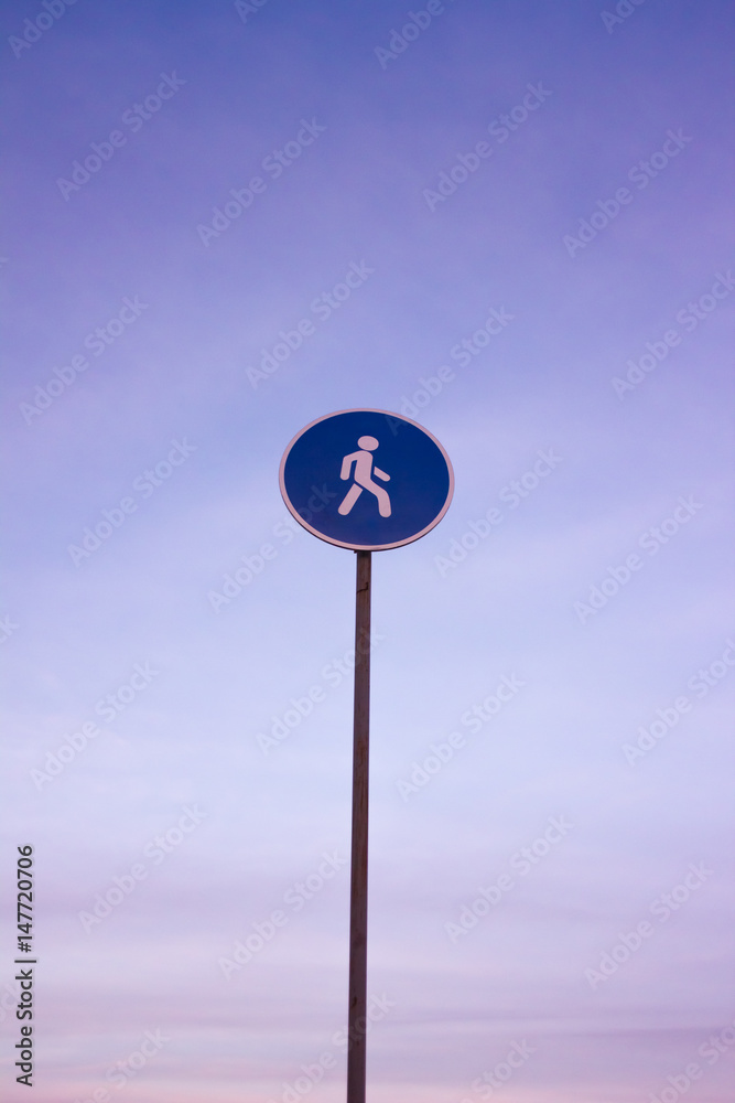 Pedestrian sign on blue sky background