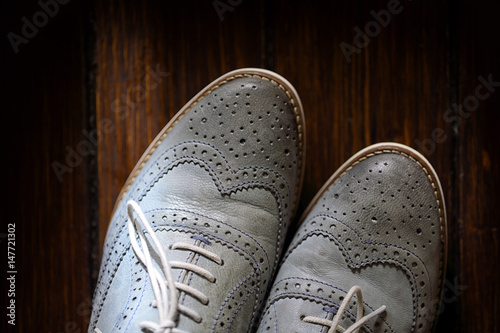 Εκτύπωση καμβά Grey oxford shoes on wooden background