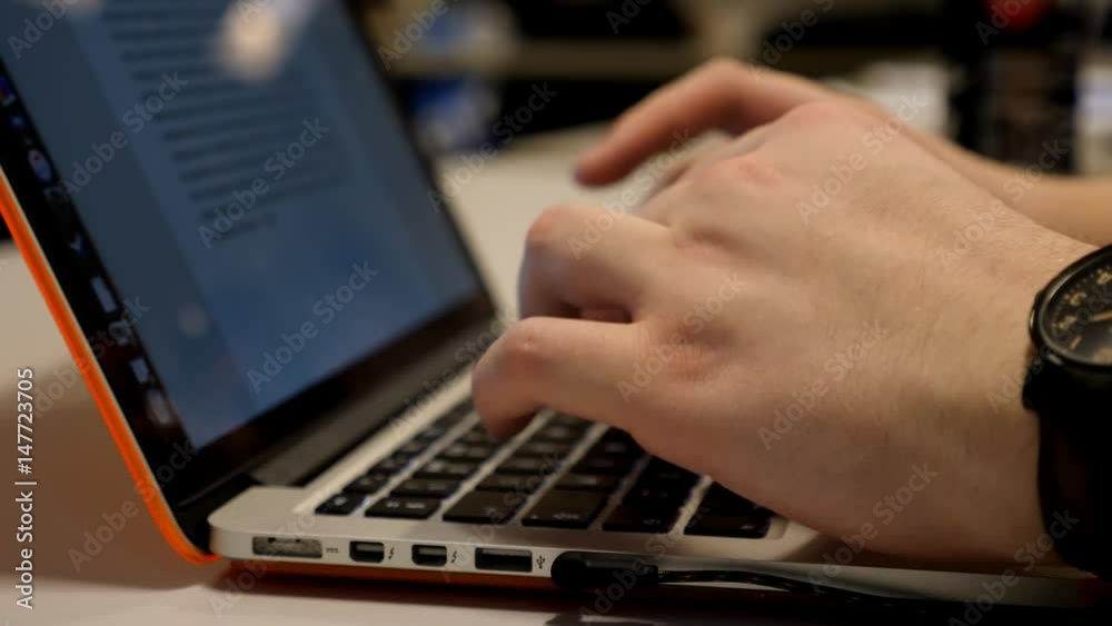 male hands working on a laptop