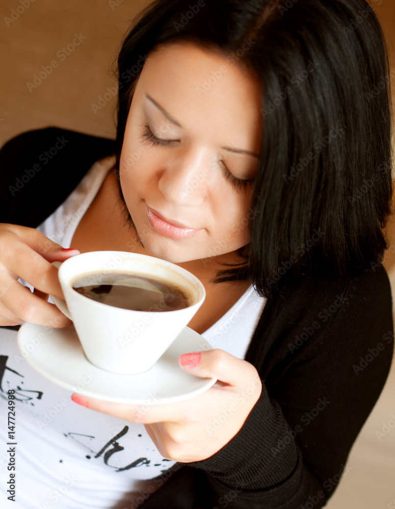 young woman sitting in a cafe drinking coffee young woman sitting in a cafe drinking coffee