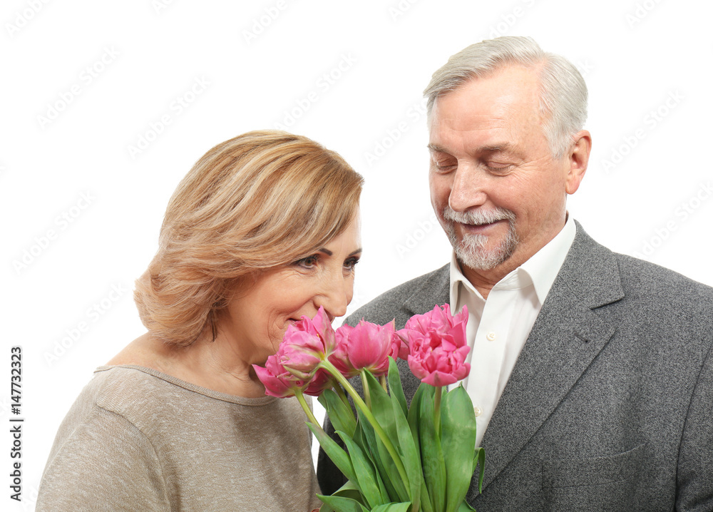Happy senior couple with bouquet of flowers isolated on white Happy senior couple with bouquet of flowers isolated on white