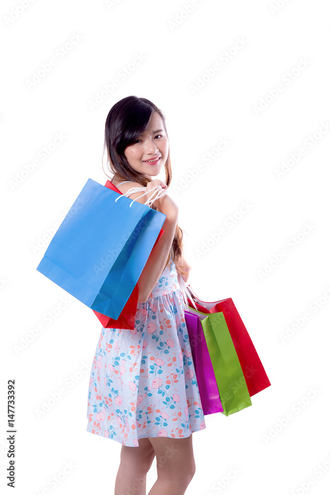 happy excited woman standing and holding colorful shopping bags isolated on a white background.