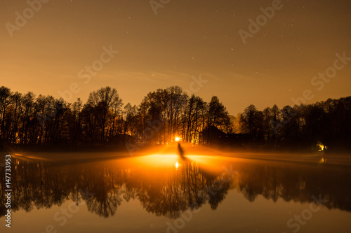 Fototapeta Naklejka Na Ścianę i Meble -  lights over a lake on a starry night