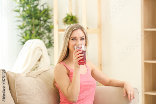 Beautiful young woman drink...
