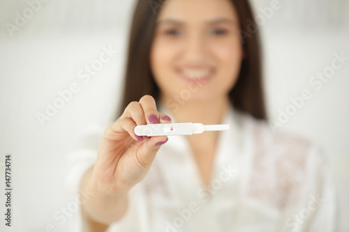 Pregnancy test in hand of young woman