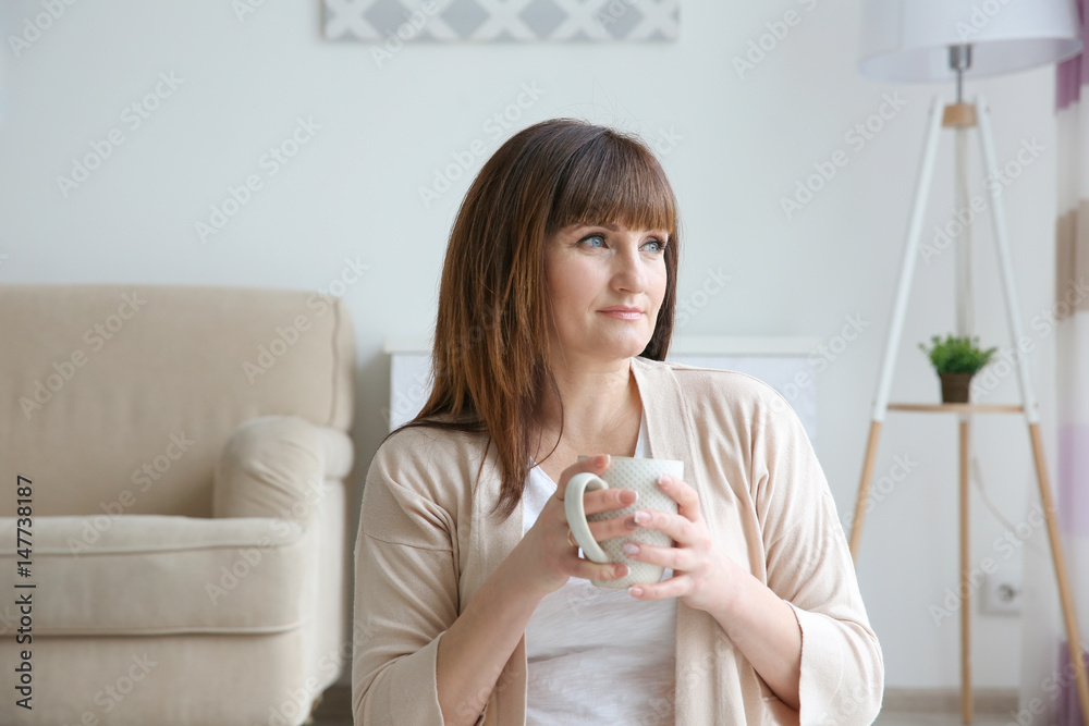 Beautiful mature woman drinking coffee at home Beautiful mature woman drinking coffee at home