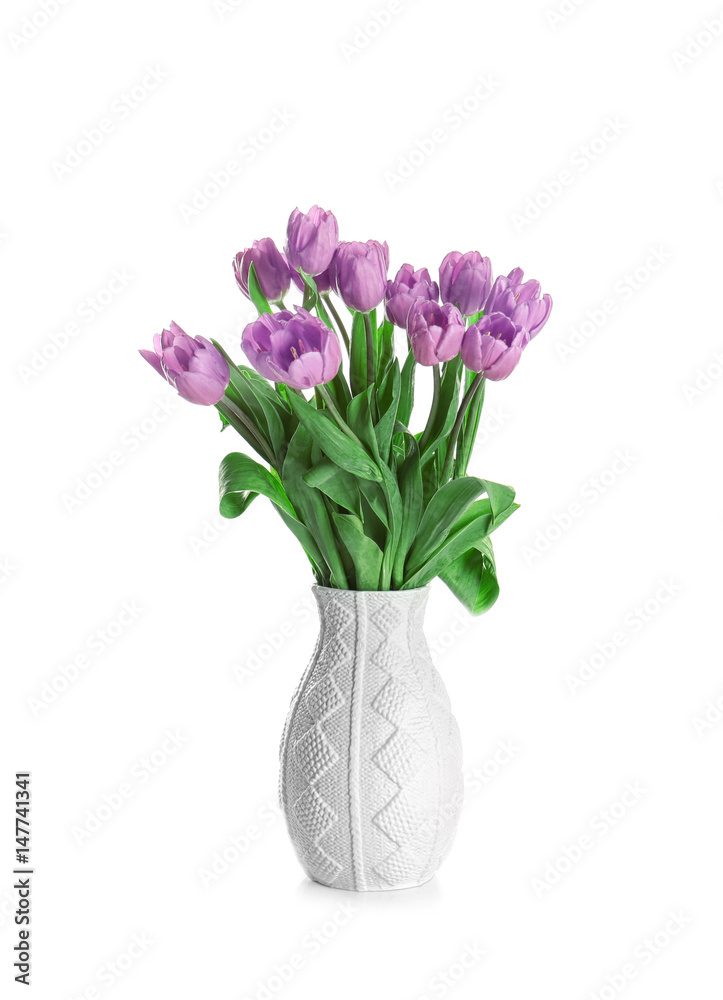 Obraz premium Vase with beautiful bouquet of lilac tulips on white background