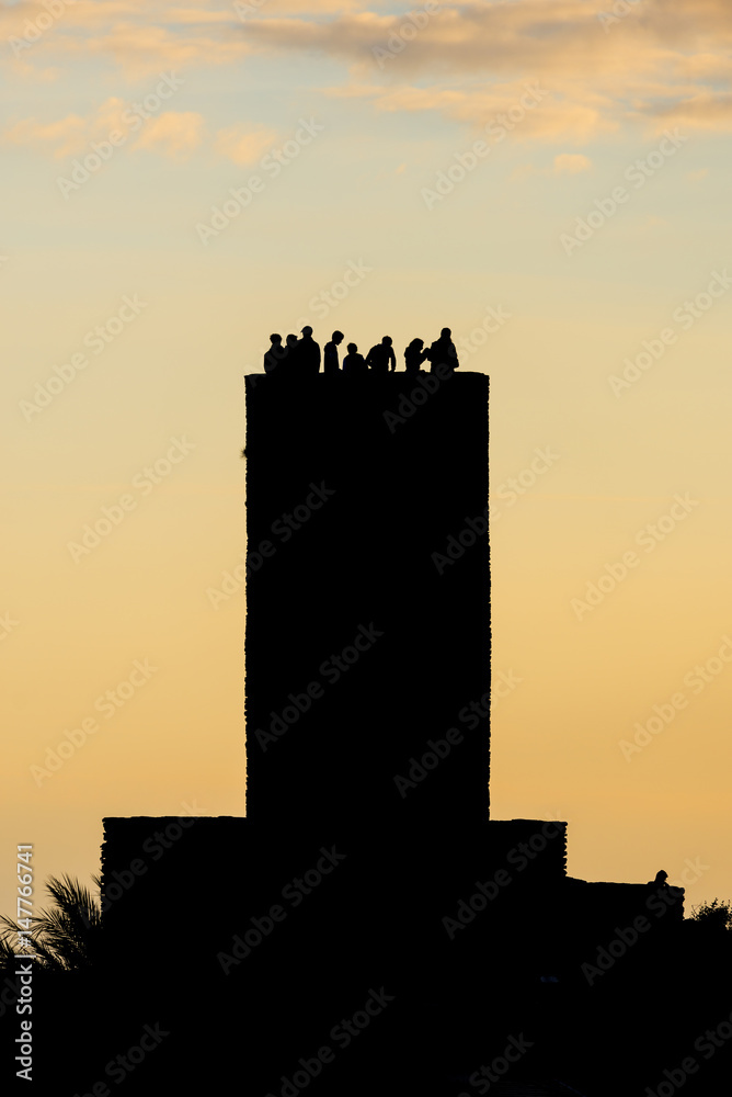 Cinque Terre Doria castle tower in Vernazza in Italy on sunset in summer with lot of turists on the top