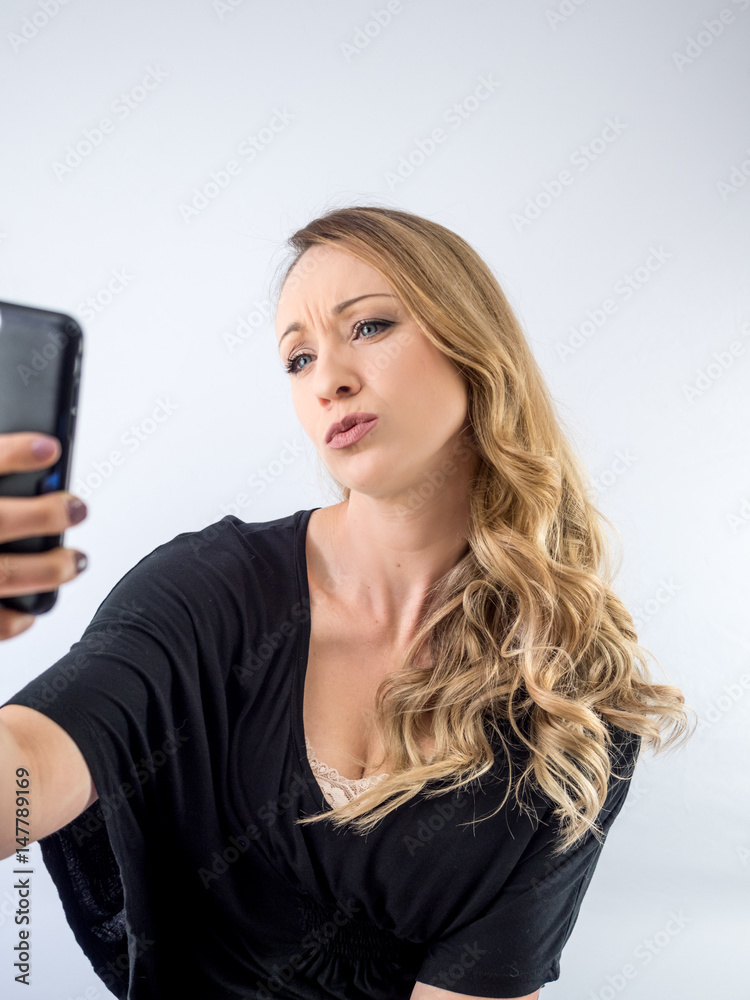 blond woman on a white background, with cellphone blond woman on a white background, with cellphone