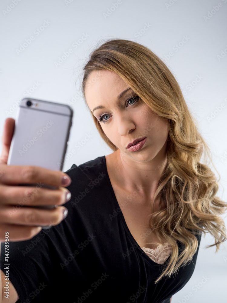 blond woman on a white background, with cellphone blond woman on a white background, with cellphone