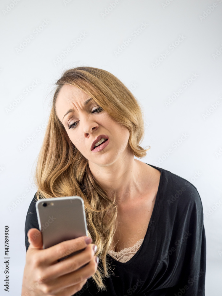 blond woman on a white background, with cellphone blond woman on a white background, with cellphone