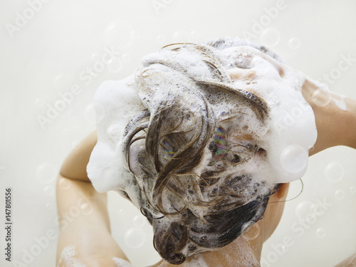 Women washing hair with more Shampoo bubbles