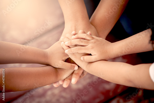 Family holding hands together in vintage color tone