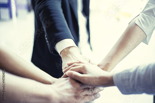 people showing unity with their hands together, teamwork and together concept