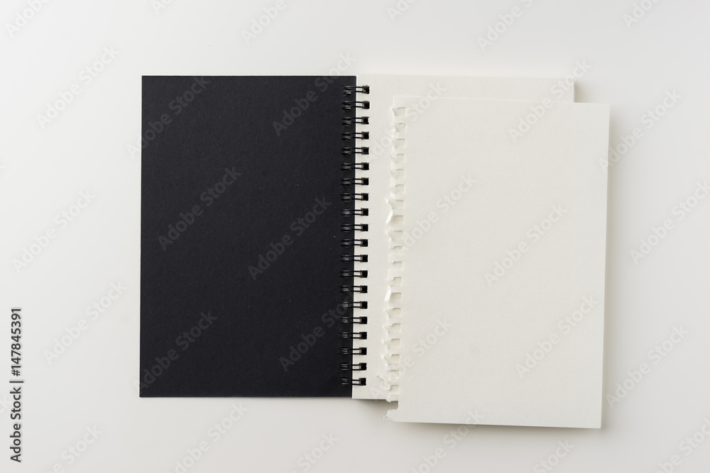 Business concept - Top view of spiral blank notebook on white background desk for mockup Business concept - Top view of spiral blank notebook on white background desk for mockup
