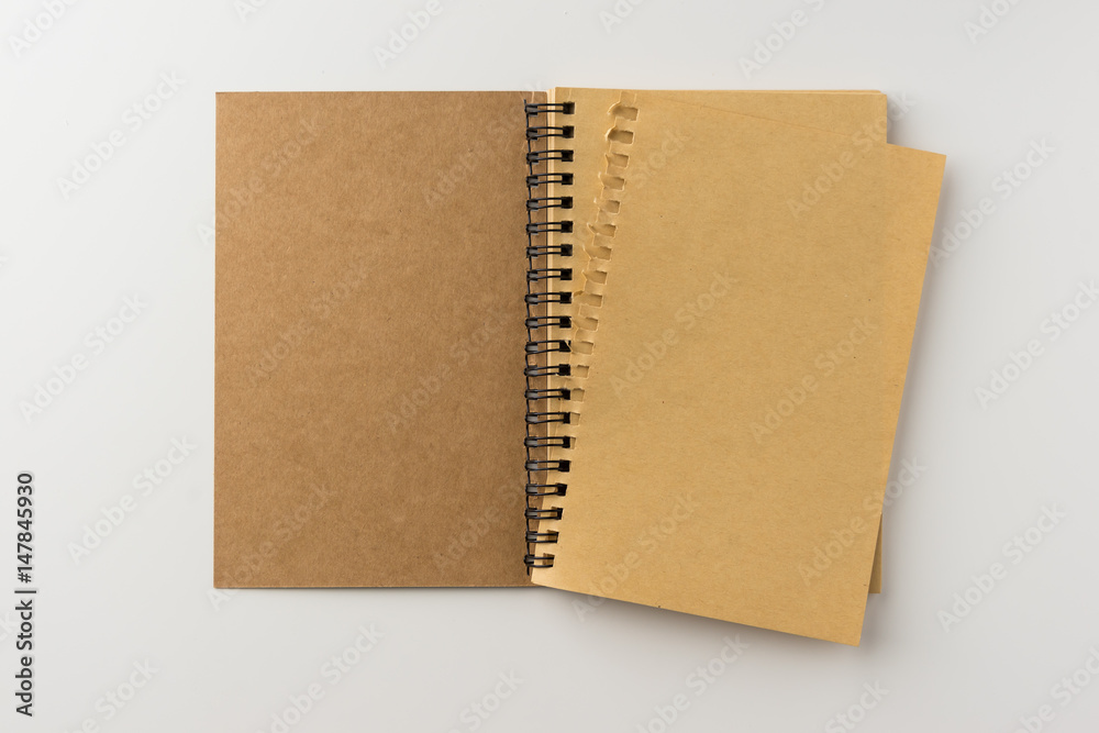 Business concept - Top view of spiral blank notebook on white background desk for mockup Business concept - Top view of spiral blank notebook on white background desk for mockup