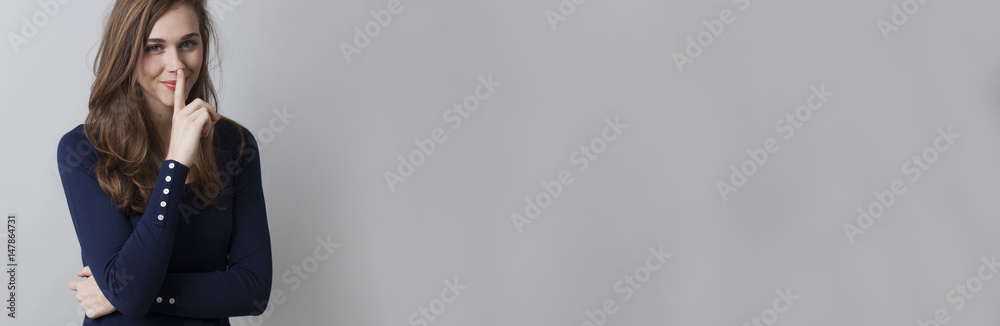 happy young woman keeping her mystery and secrets for herself