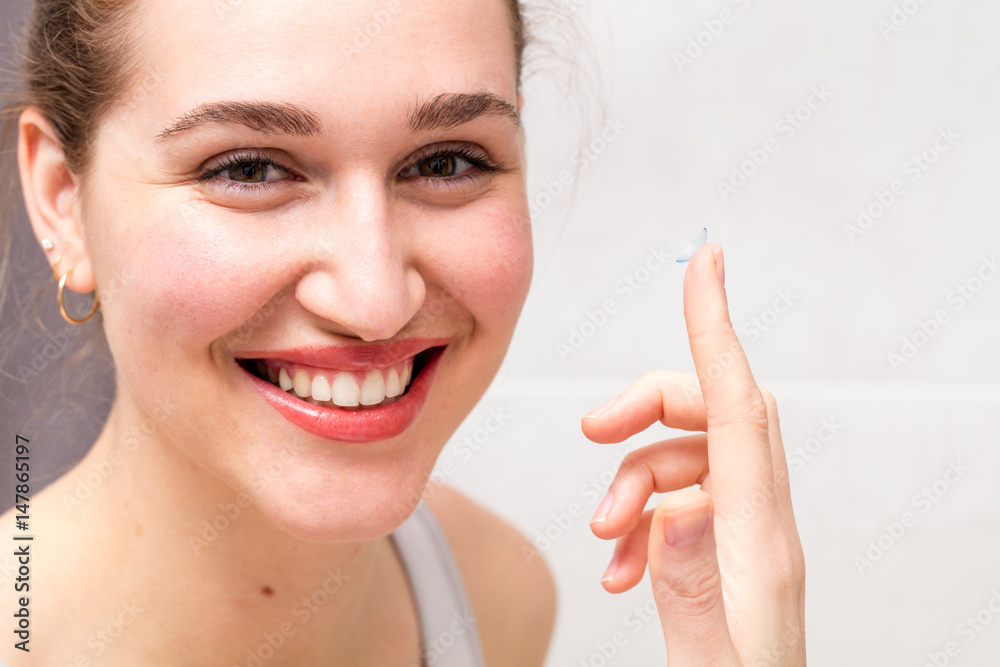 smiling beautiful girl preparing to apply or remove contact lens smiling beautiful girl preparing to apply or remove contact lens