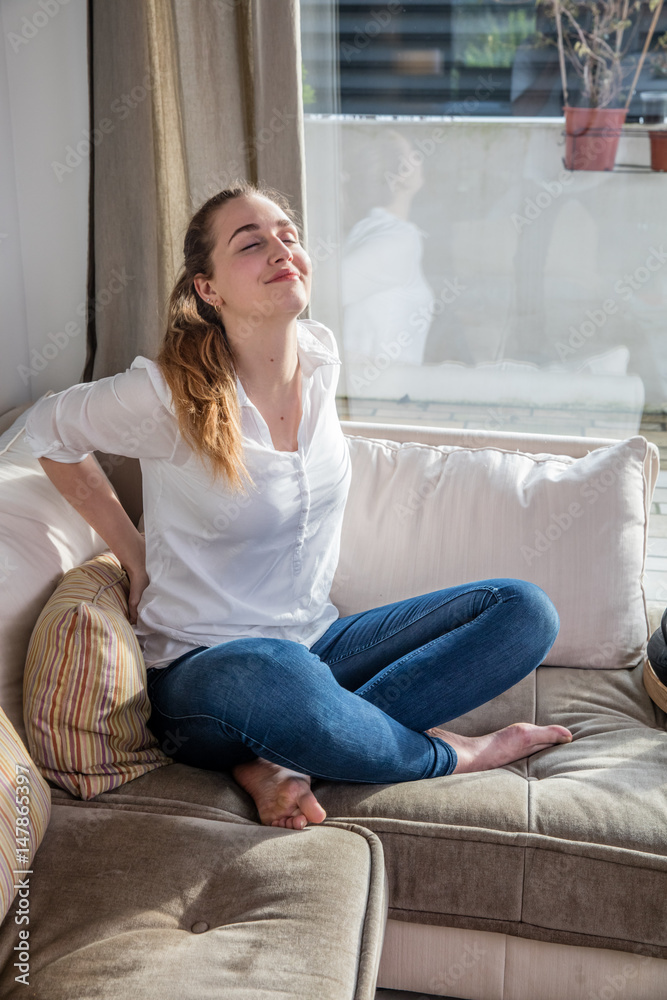 smiling beautiful young woman enjoying relaxing her back for wellness smiling beautiful young woman enjoying relaxing her back for wellness