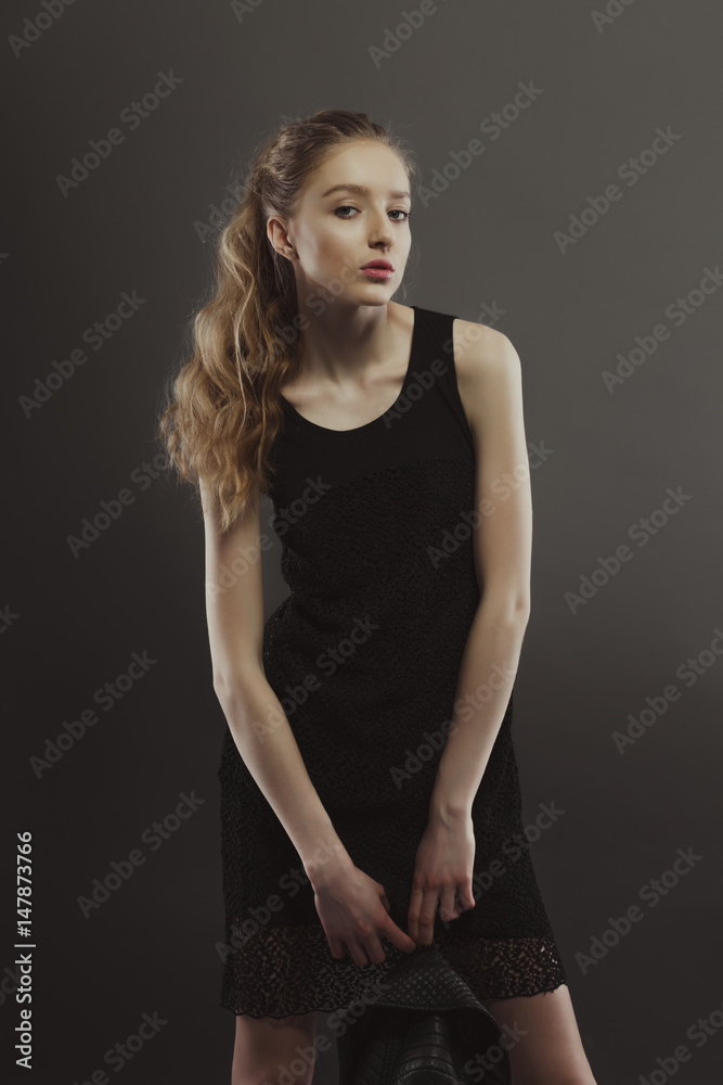 Beautiful young model posing for model tests holding leather jacket Beautiful young model posing for model tests holding leather jacket