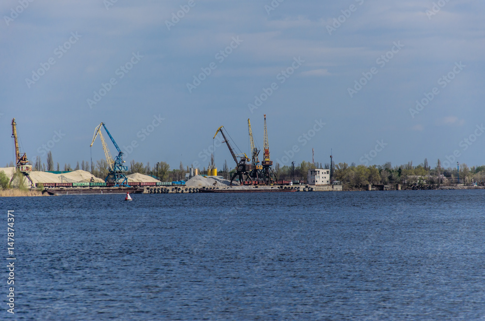 Cranes in cargo port on a river Dnieper in Kremenchug, Ukraine