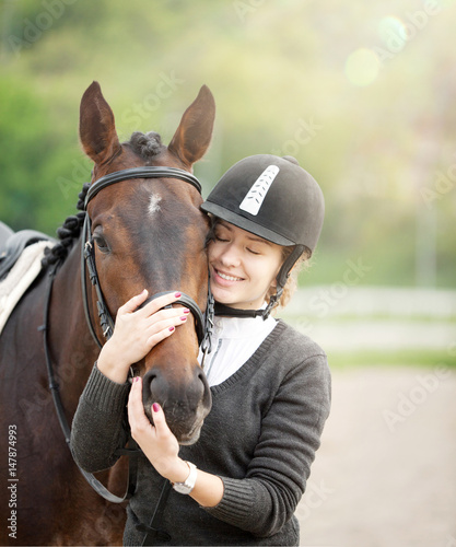 Attractive Young Woman Embracing her Horse