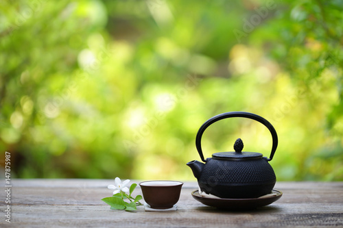 Black vintage teapot and cup at outdoor