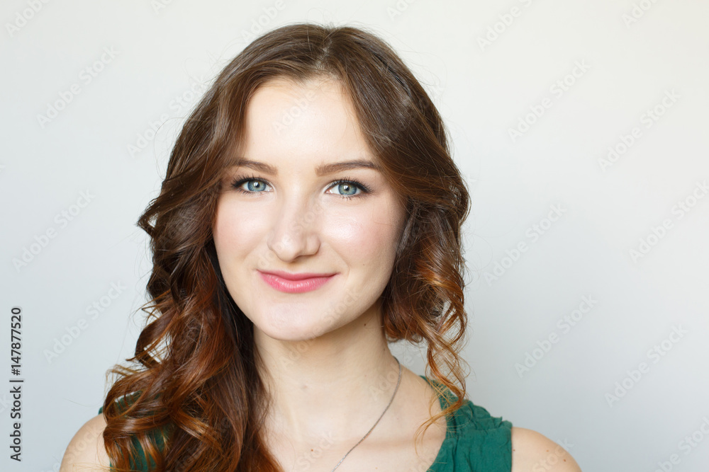 Young brown-haired girl portrait. Fresh makeup. White background. Studio photo. Happy elegant lady. Curled hairstyle Young brown-haired girl portrait. Fresh makeup. White background. Studio photo. Happy elegant lady. Curled hairstyle