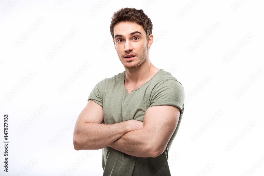 handsome man standing with crossed arms and looking at camera isolated on white handsome man standing with crossed arms and looking at camera isolated on white