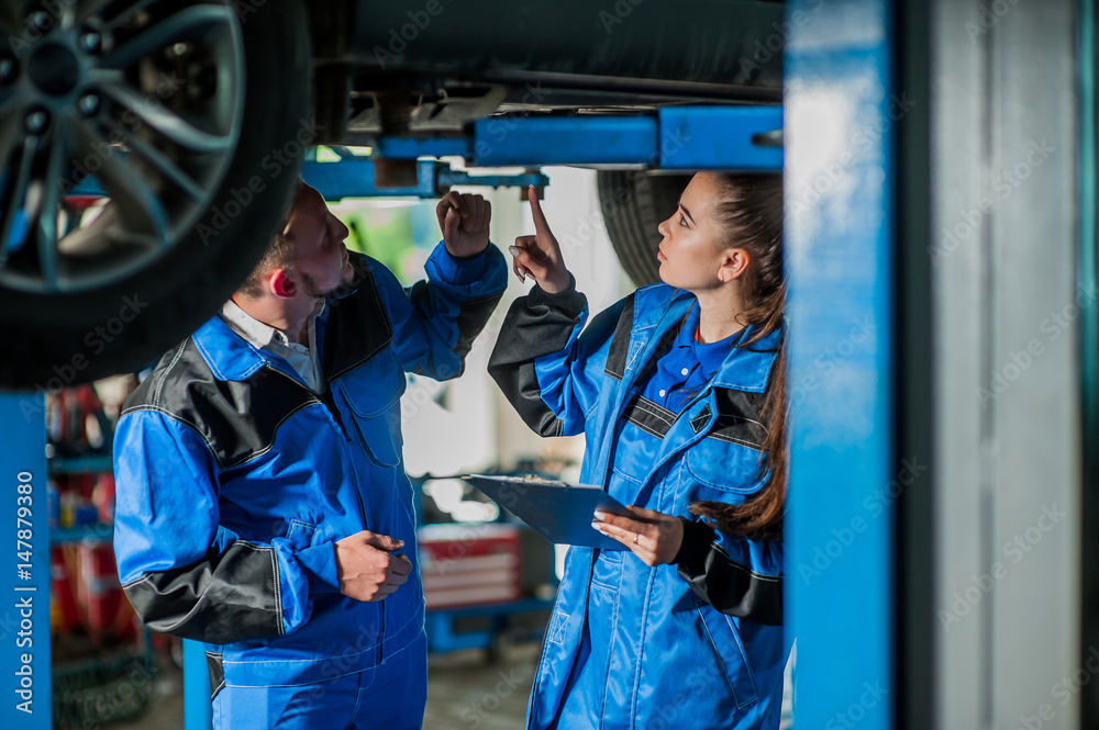 Man and woman in auto mechanics Man and woman in auto mechanics