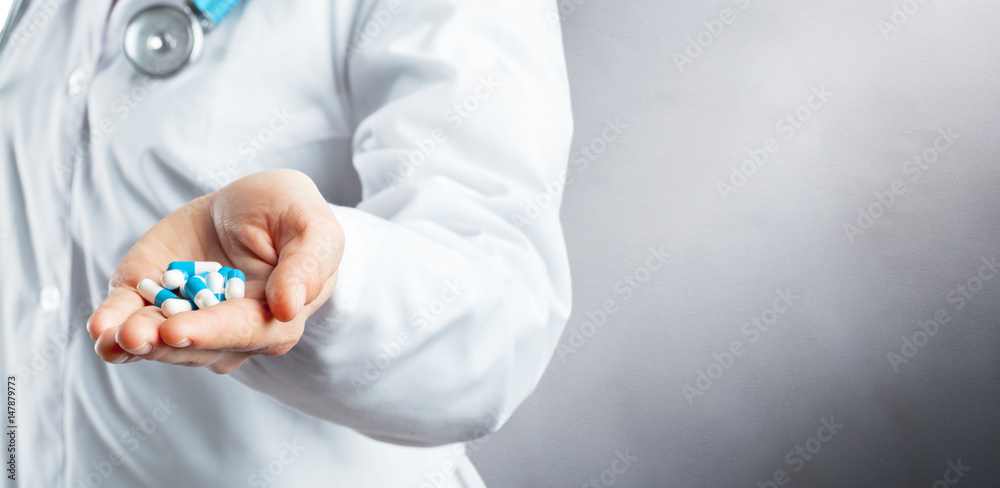 Doctor holding pills