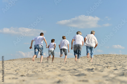 Family running through the sand