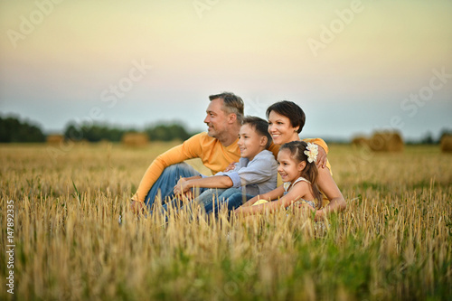 Happy parents with children at sunset