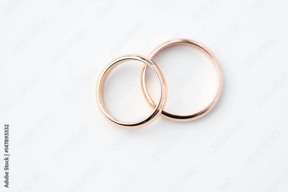 two golden wedding rings isolated on white, wedding rings background concept two golden wedding rings isolated on white, wedding rings background concept