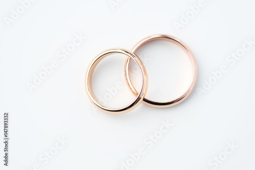 two golden wedding rings isolated on white, wedding rings background concept photo