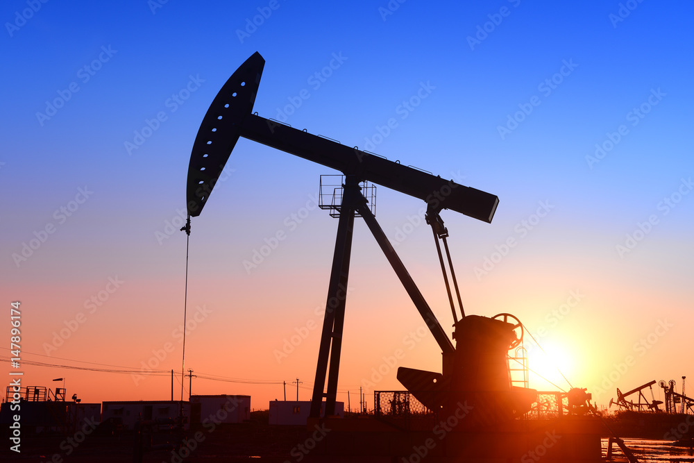 Pumping unit is working, under the sunset Pumping unit is working, under the sunset