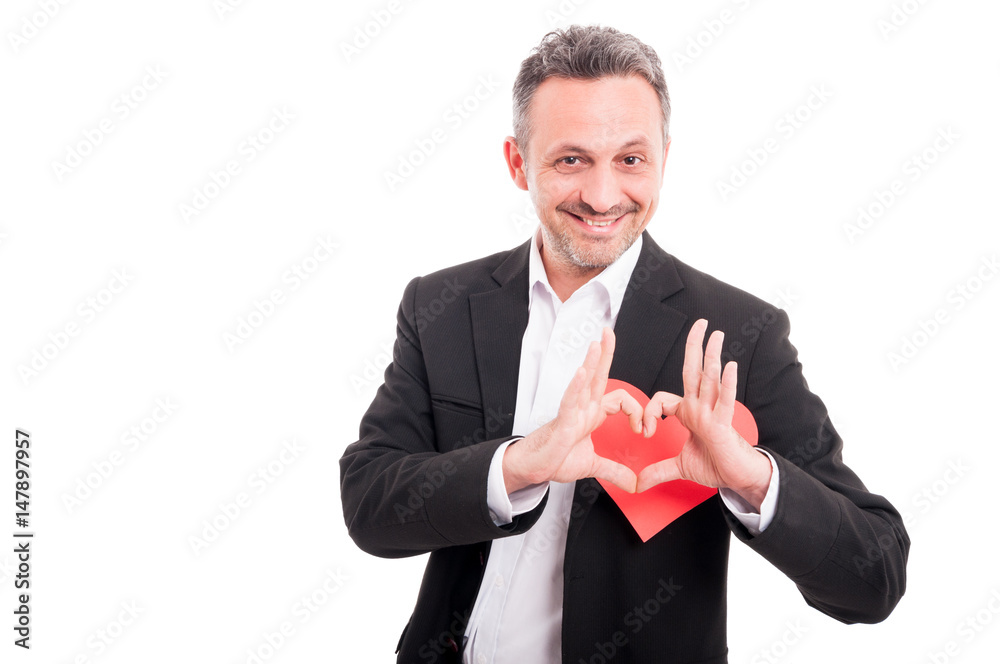 Romantic young man holding heart shaped valentine card Romantic young man holding heart shaped valentine card