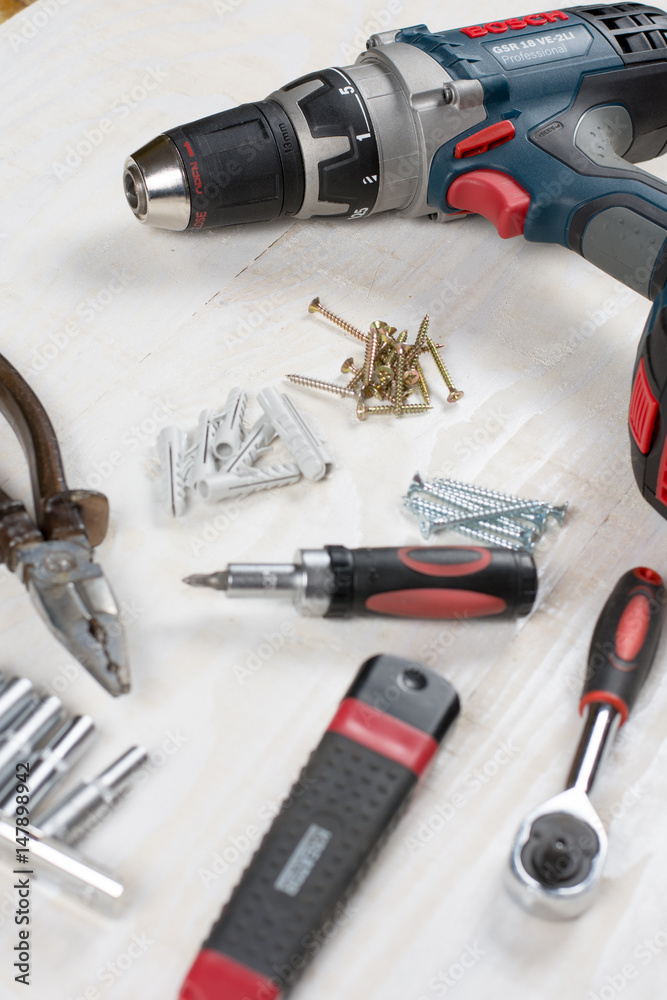 Acu drill screwdriver rachet and tools flat lay over wooden background Acu drill screwdriver rachet and tools flat lay over wooden background