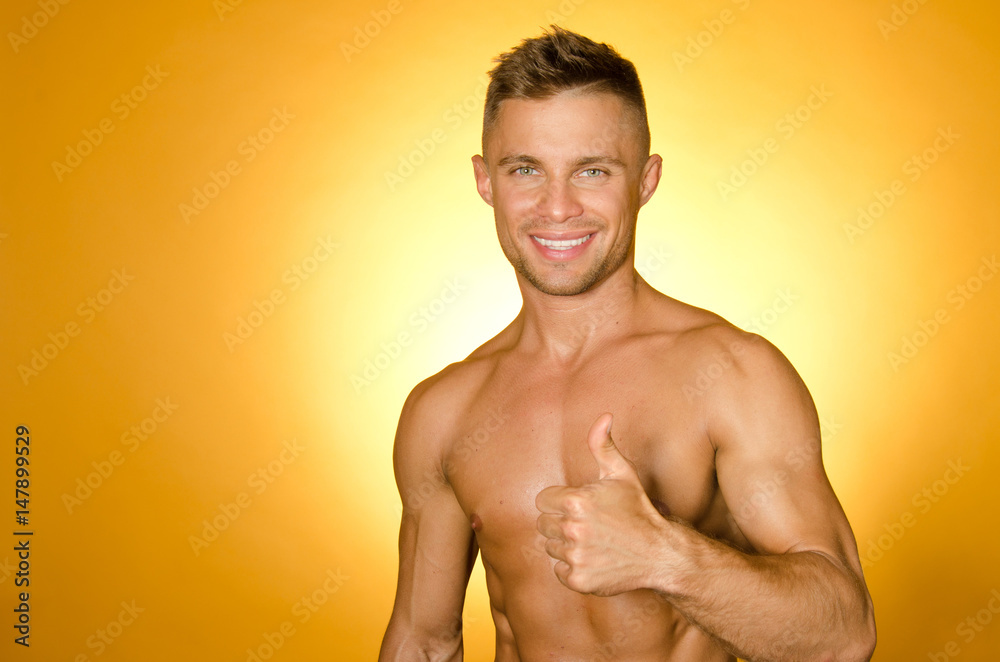 Fototapeta premium Okay. A happy guy without a shirt. Summer and rest. 