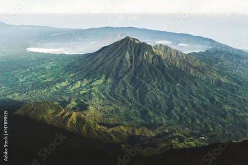 View of Batur Caldera and Gunung Abang from mount Agung in Bali at sunrise summit. Top of Agung Volcano. Agung trekking and hiking.