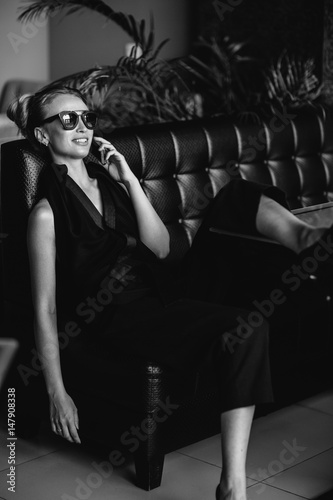 Portrait of a beautiful woman smiling pretty happy smiling, wearing sunglasses. Fashion style