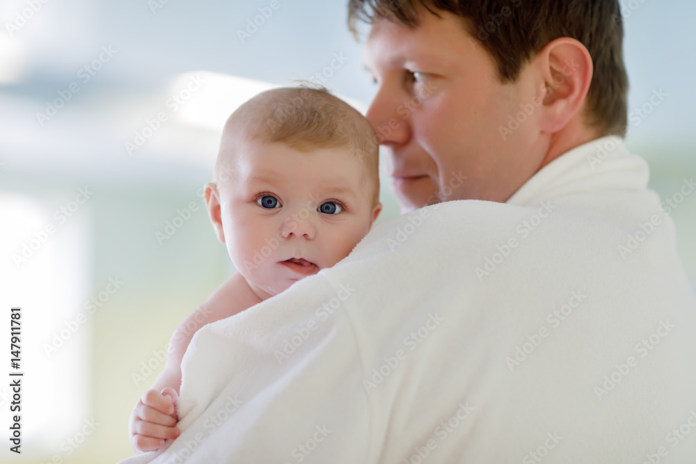 Young father and his little cute newborn baby daughter together in spa hotel. Young father and his little cute newborn baby daughter together in spa hotel.