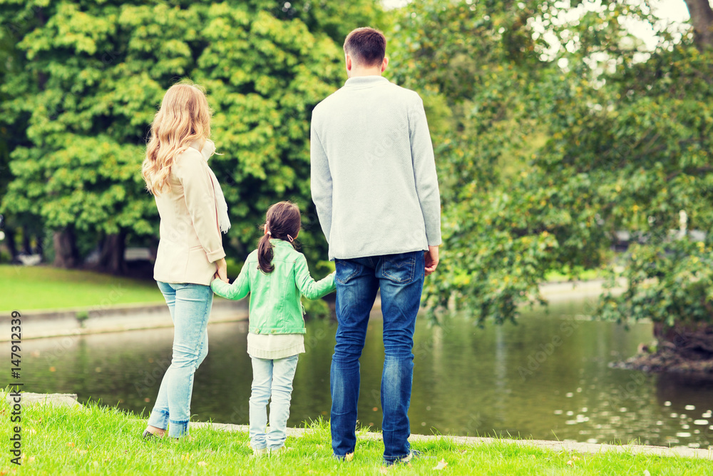 family walking in summer park