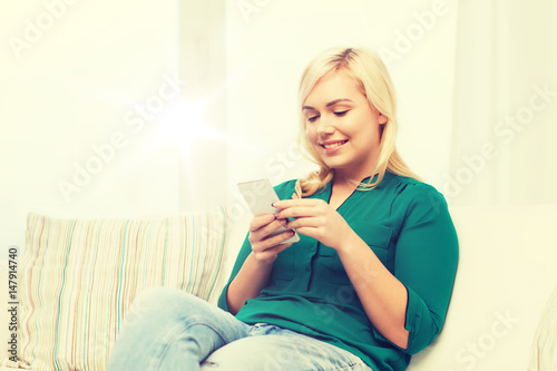 happy woman with smartphone at home