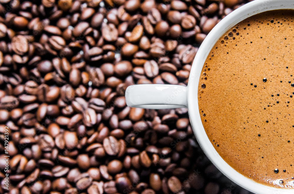 Coffee cup and coffee beans on table, top view, love coffee, Brown coffee beans isolated on white background, Hot Coffee cup with Coffee beans Coffee cup and coffee beans on table, top view, love coffee, Brown coffee beans isolated on white background, Hot Coffee cup with Coffee beans