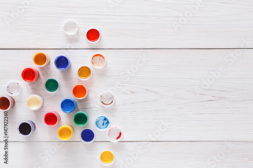 Artist workplace, set of color paints on wood desk